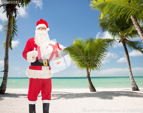 Image of man in costume of santa claus with gift box