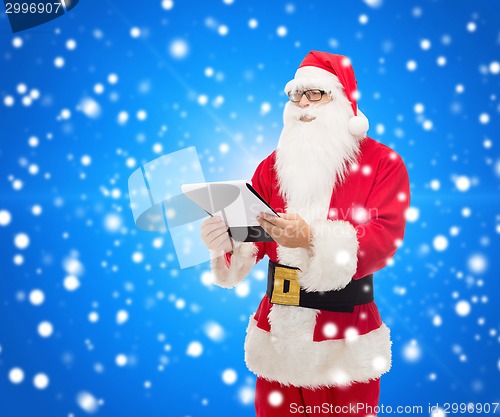Image of man in costume of santa claus with notepad