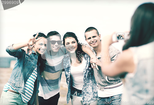 Image of teenagers taking photo outside