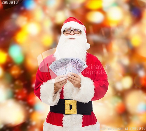 Image of man in costume of santa claus with euro money