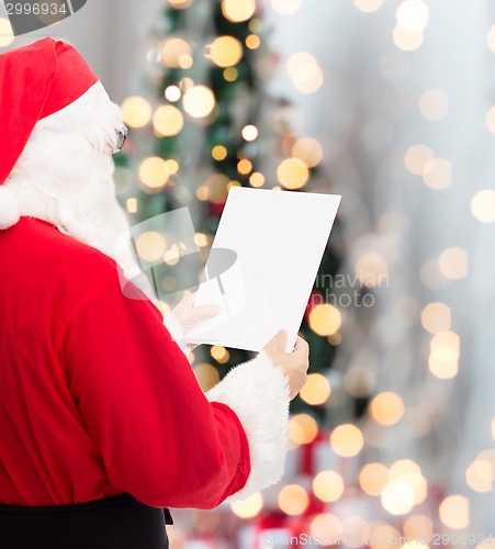 Image of man in costume of santa claus with letter