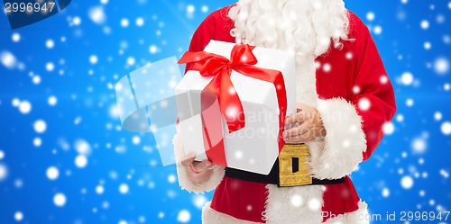 Image of man in costume of santa claus with gift box