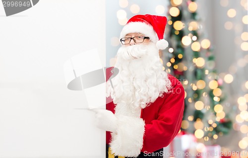 Image of man in costume of santa claus with billboard