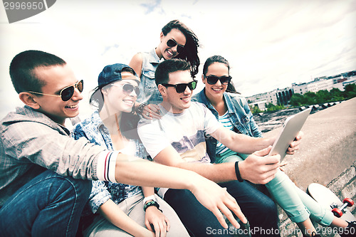 Image of group of teenagers looking at tablet pc