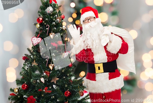 Image of santa claus with bag and christmas tree