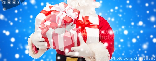 Image of man in costume of santa claus with gift box