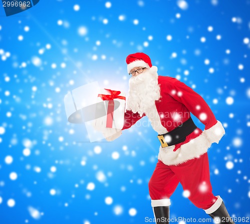 Image of man in costume of santa claus with gift box