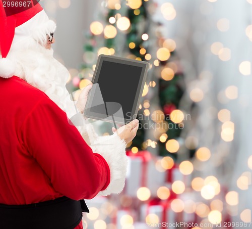 Image of man in costume of santa claus with tablet pc