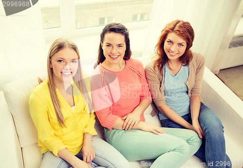 Image of three girlfriends having a talk at home