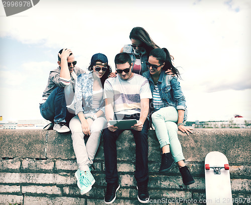 Image of group of teenagers looking at tablet pc