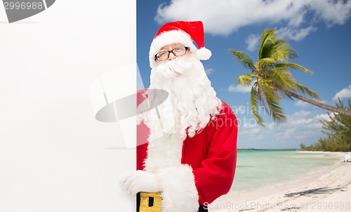 Image of man in costume of santa claus with billboard