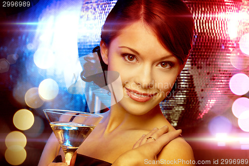 Image of woman with cocktail and disco ball