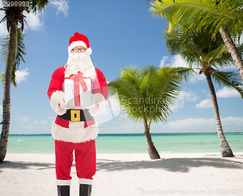 Image of man in costume of santa claus with gift box