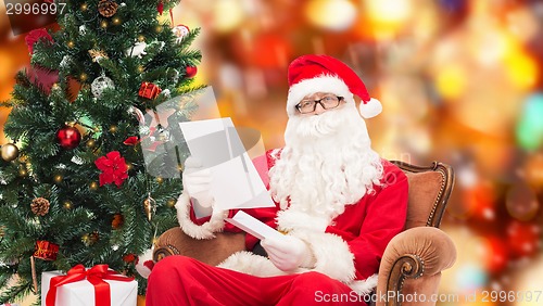 Image of man in costume of santa claus with letter