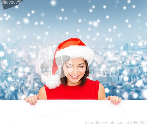 Image of woman in santa helper hat with blank white board