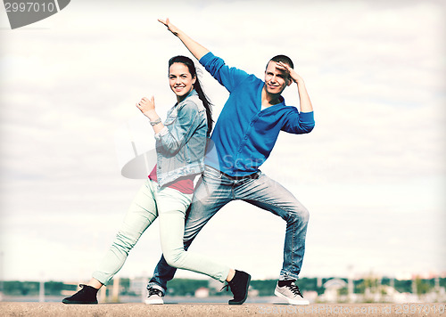 Image of couple of teenagers dancing outside