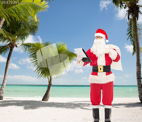Image of man in costume of santa claus with notepad and bag