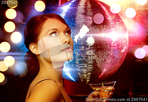 Image of woman with cocktail and disco ball