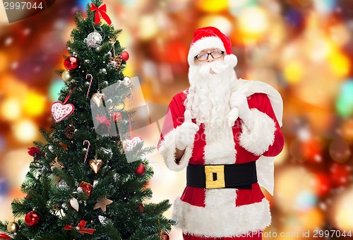 Image of santa claus with bag and christmas tree