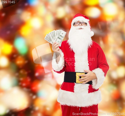 Image of man in costume of santa claus with dollar money