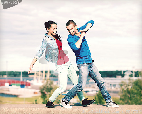 Image of couple of teenagers dancing outside