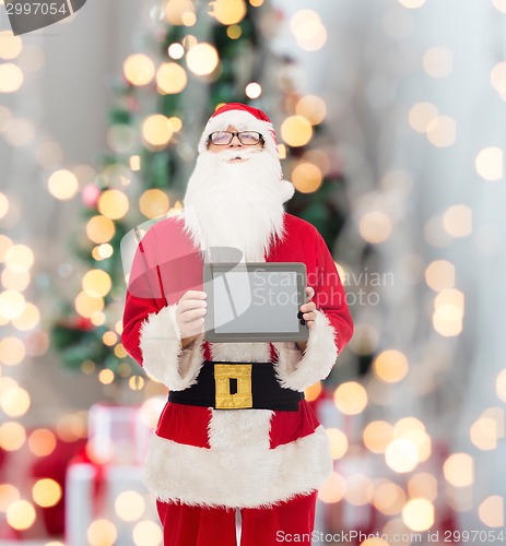 Image of man in costume of santa claus with tablet pc