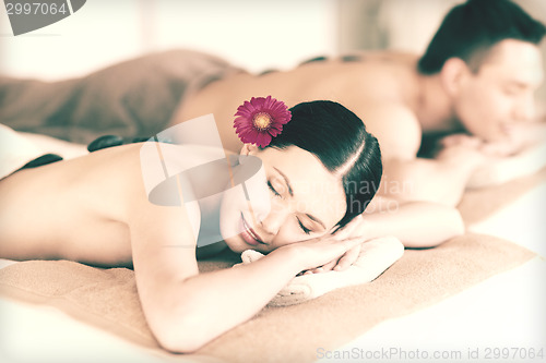 Image of couple in spa with hot stones