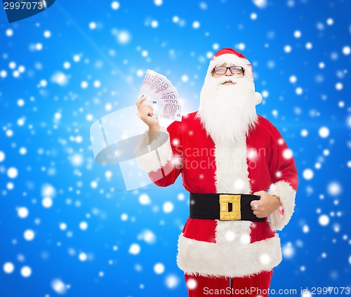 Image of man in costume of santa claus with euro money