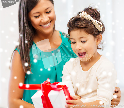 Image of happy mother and child girl with gift box