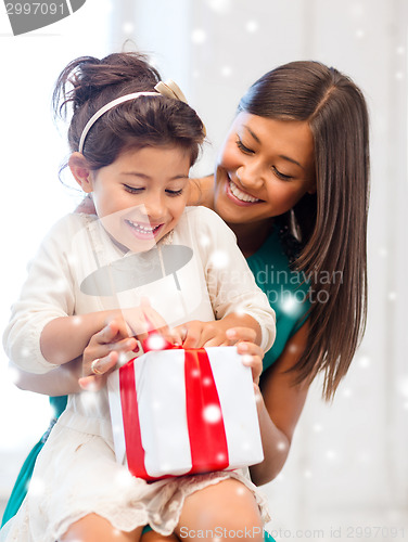 Image of happy mother and child girl with gift box