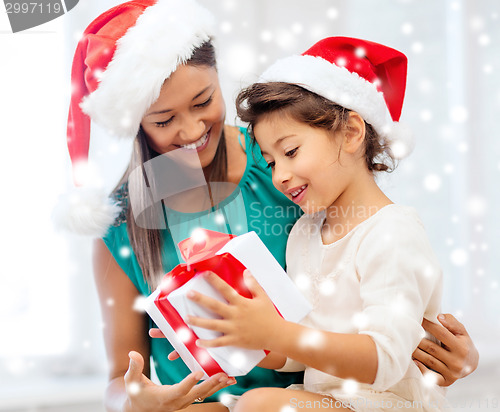 Image of happy mother and child girl with gift box