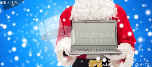 Image of close up of santa claus with laptop