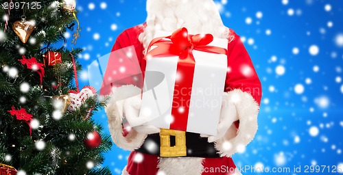 Image of man in costume of santa claus with gift box