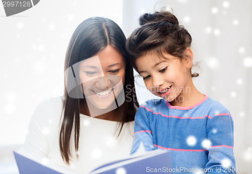 Image of mother and daughter with book indoors