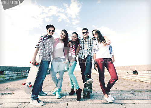 Image of teenagers with skates outside