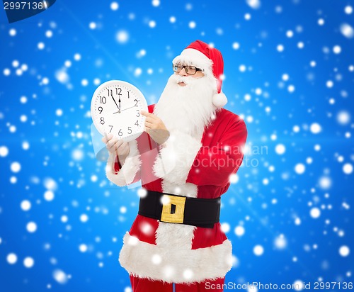 Image of man in costume of santa claus with clock