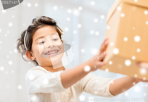 Image of smiling little girl with gift box