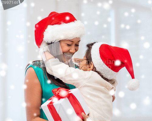 Image of happy mother and child girl with gift box