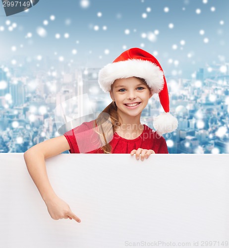 Image of girl in santa helper hat with blank white board