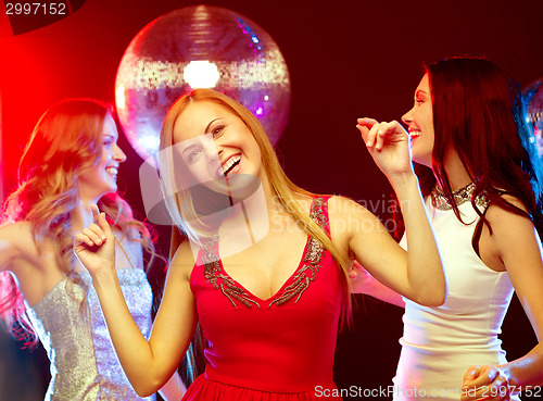 Image of three smiling women dancing in the club