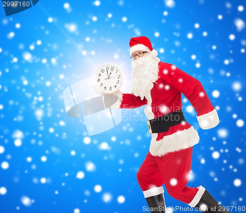 Image of man in costume of santa claus with clock