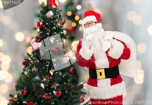 Image of santa claus with bag and christmas tree