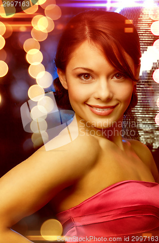 Image of woman in evening dress wearing diamond earrings