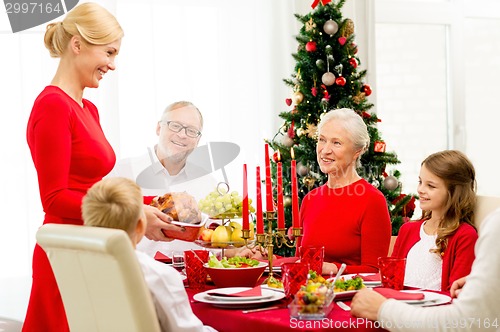 Image of smiling family having holiday dinner at home