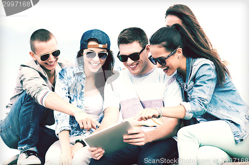 Image of group of teenagers looking at tablet pc