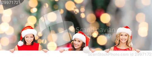 Image of women in santa helper hat with blank white board