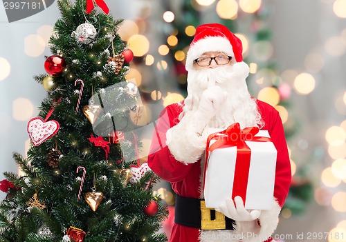 Image of man in costume of santa claus with gift box