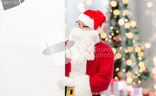 Image of man in costume of santa claus with billboard