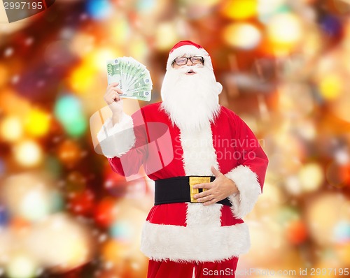 Image of man in costume of santa claus with euro money