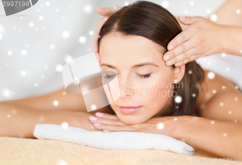 Image of beautiful woman getting face or head massage